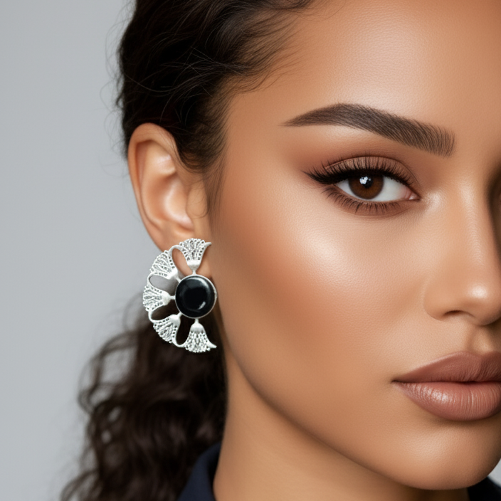 Close-up of a woman wearing a decorative earring with a statement oxidized stone earrings showcasing intricate stone setting and antique finish.