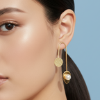Close-up of a woman wearing elegant inverted U gold earrings.
