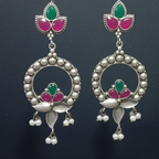 Close-up of oxidized statement earrings showing intricate detailing and secure stone settings.
