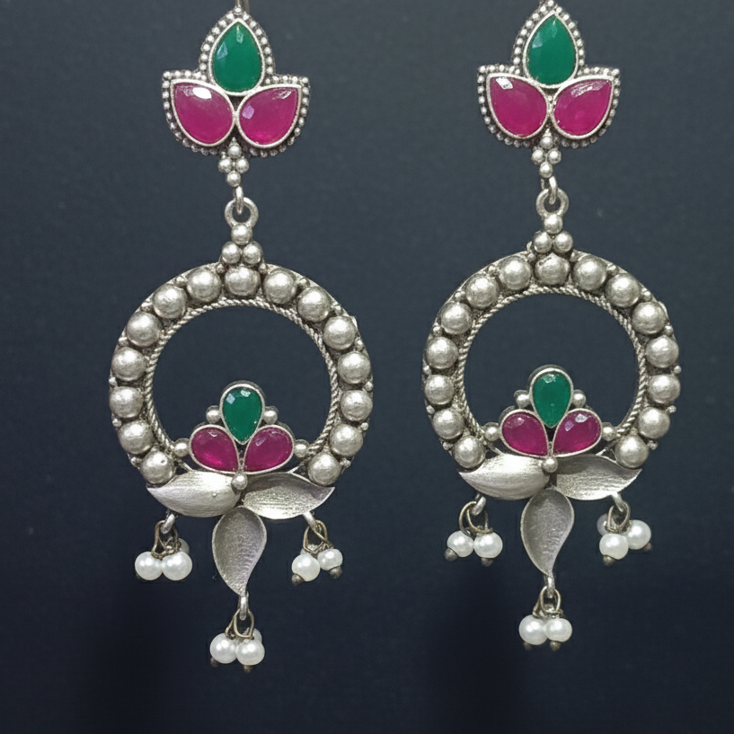 Close-up of oxidized statement earrings showing intricate detailing and secure stone settings.