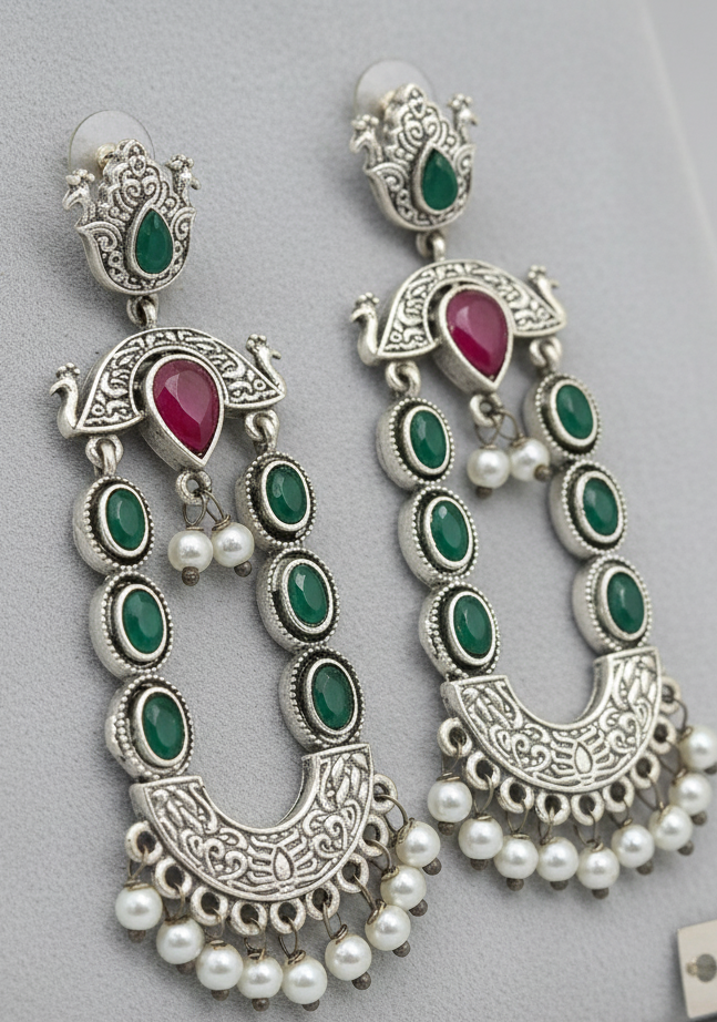 Ornate earrings with green, red, and pearl accents 