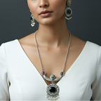 Woman wearing a silver necklace with black and red accents and matching earrings.