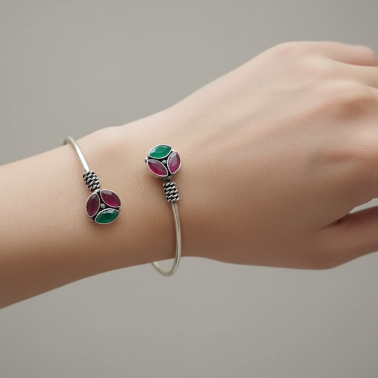 A model's hand adorned with elegant multicolor oxidised silver Kundan bracelet for women, perfect everyday wear.