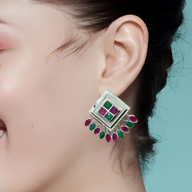 Close-up of a woman wearing A Colorful Oxidized Silver Peacock Stud Earrings