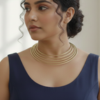 A woman wearing blue dress & multi layered contemporary gold look hasli necklace for office wear and parties.