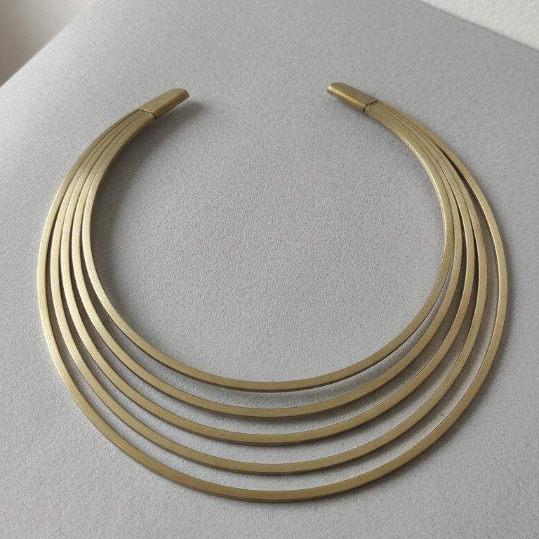 Multi layered contemporary gold look hasli necklace for office wear and parties, on a white background .