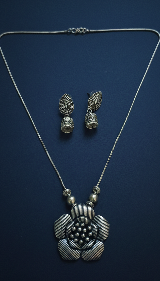 Oxidized Statement Pendant Set for Women on the blue background.