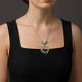 Woman wearing a black dress and Flower of Life German Silver Necklace