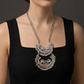 Woman wearing a  an oxidised Meenakari necklace with intricate detailing.