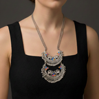 Woman wearing a  an oxidised Meenakari necklace with intricate detailing.
