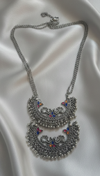 Close-up of an oxidised Meenakari necklace with intricate detailing.
