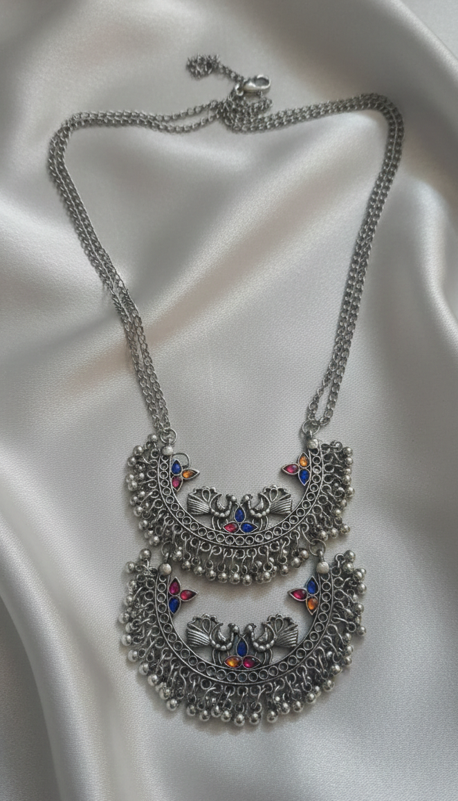 Close-up of an oxidised Meenakari necklace with intricate detailing.