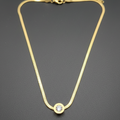 Dainty gold necklace with a polished finish, showcasing its elegant and minimalist design.