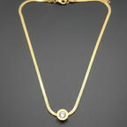 Dainty gold necklace with a polished finish, showcasing its elegant and minimalist design.