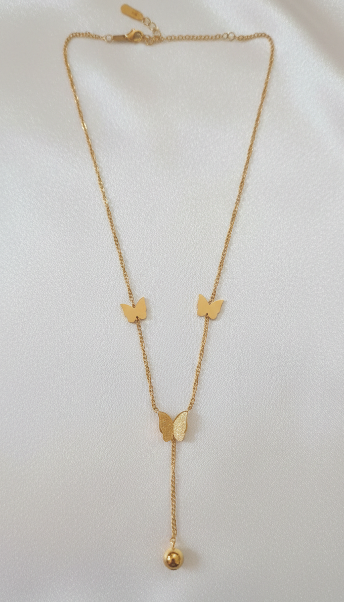 Gold necklace withbutterfly pendants on a white background