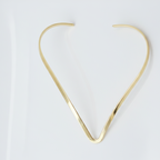 Gold hasli necklace on a white background