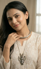 Woman wearing a oxidised hasli & necklace stack 