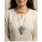 Woman wearing a elegant necklace stack complementing both ethnic and western wear.