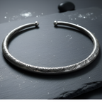 Silver hasli with textured design on a dark surface