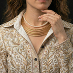 Woman wearing a Stackable Hasli Necklace with pearl necklace for the Modern Indian Professional