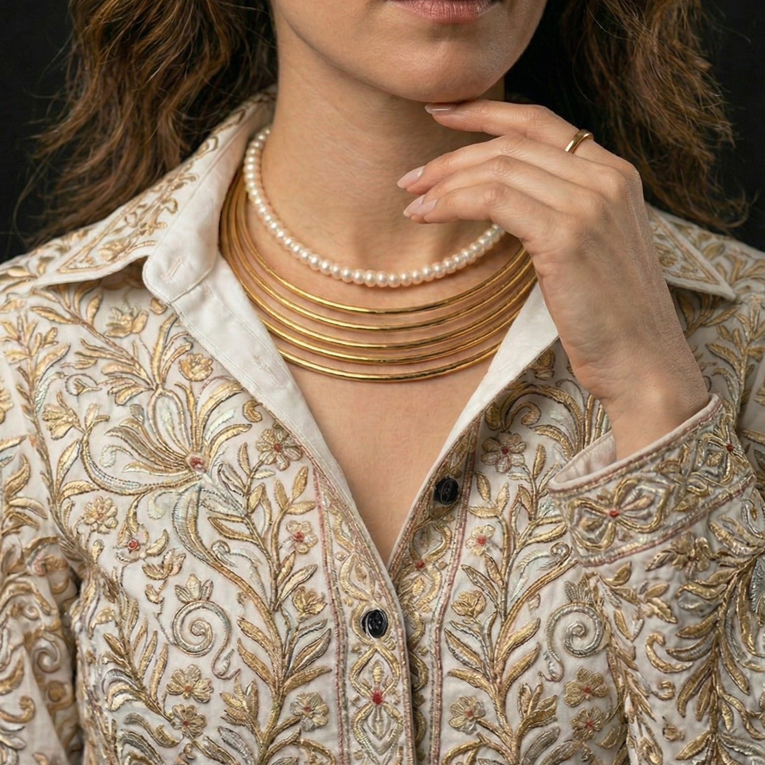 Woman wearing a Stackable Hasli Necklace with pearl necklace for the Modern Indian Professional