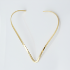 Gold hasli necklace on a white background