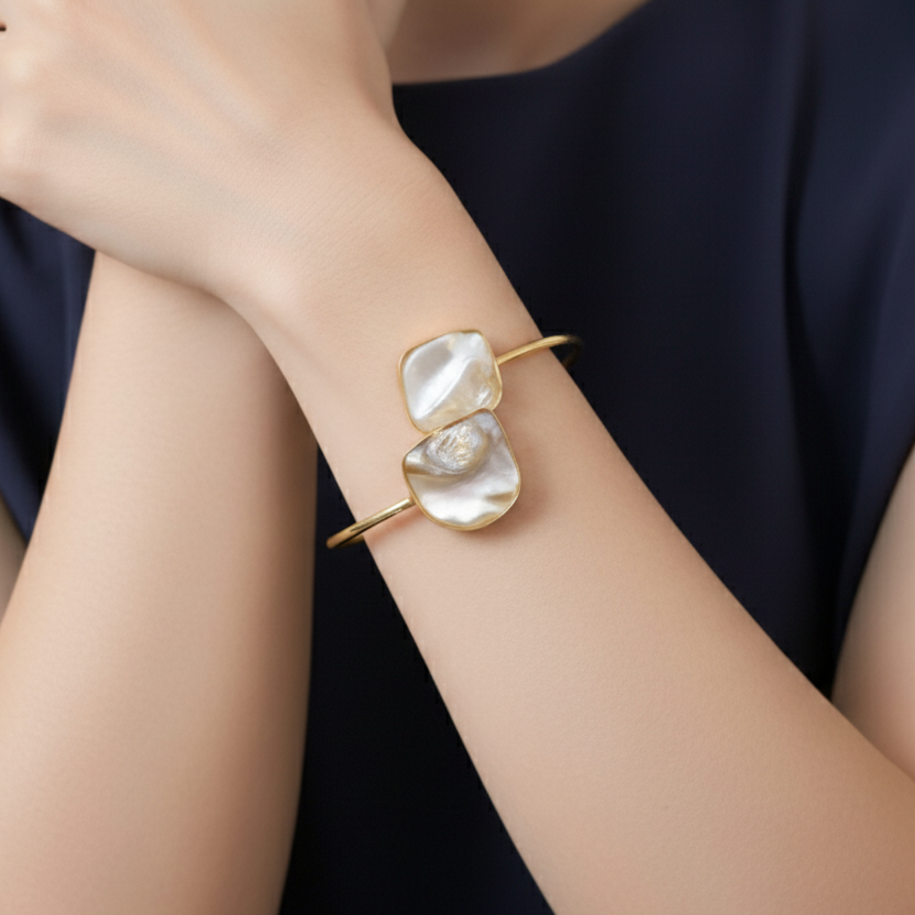 Offwhite natural raw stone gold bracelet, adjustable, elegant, modern, , on a person's wrist against a dark background