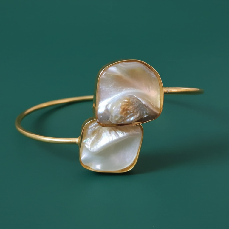 Offwhite natural raw stone gold bracelet, adjustable, elegant, modern, displayed on a dark background.
