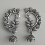 Pair of Oxidized jhumki earcuffs showcasing intricate tribal design.