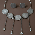  Handcrafted oxidised hasli coin necklace set for women,displayed against solid background.