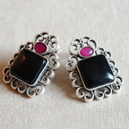 Black & Pink Oxidised stone stud earrings on a white background, close-up.