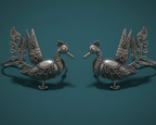 Pair of ornate silver peacock-shaped earcuff on a teal background