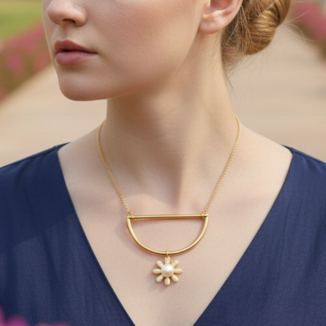 Woman wearing a gold pearl pendant necklace, a everyday wear.