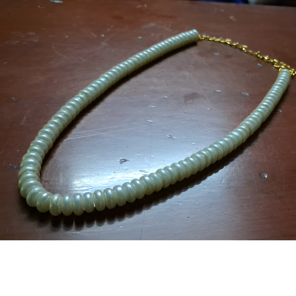 Offwhite Pearl Necklace on a wooden surface