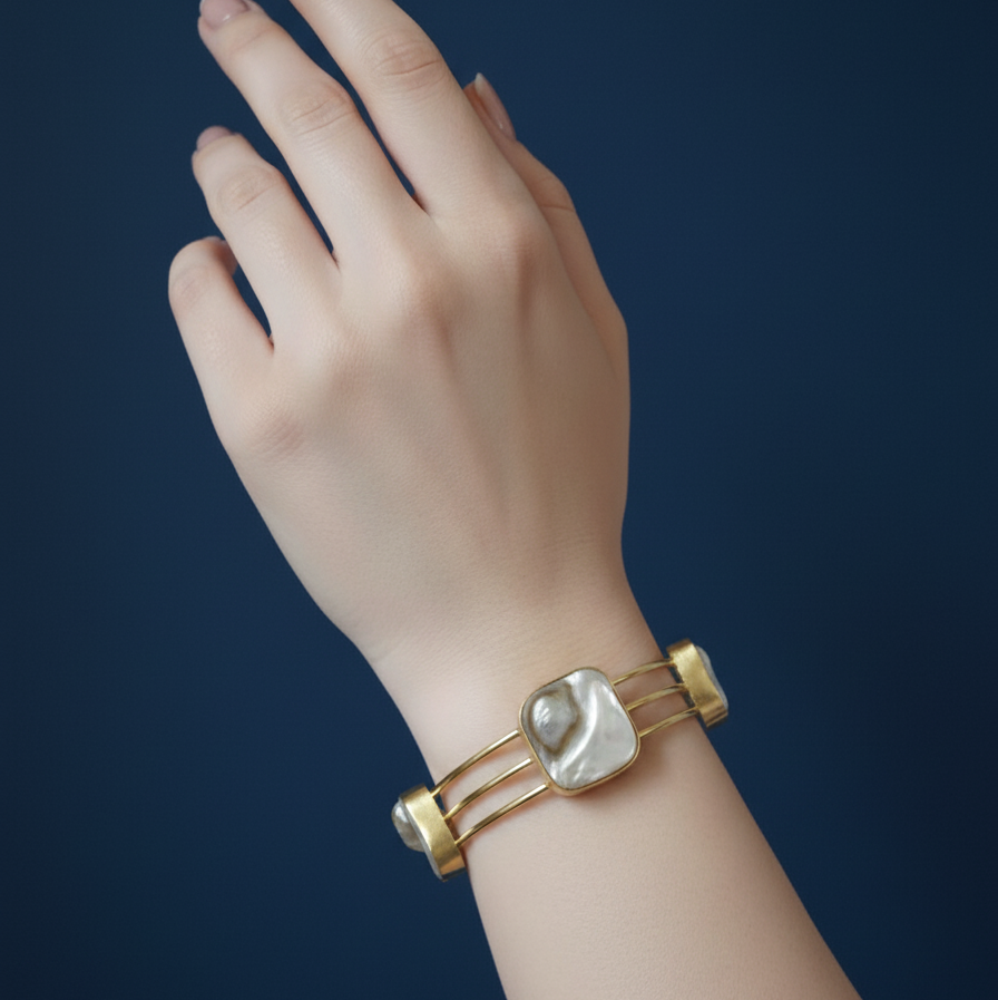 A woman's hand adorned with uncut stone gold cuff bracelet imitation with raw finish for women .