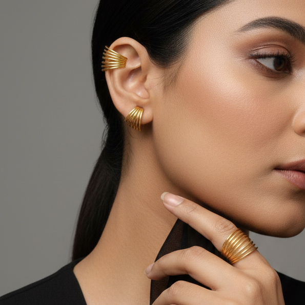 Woman wearing elegant gold earcuffs that can be versatility be used as ring
