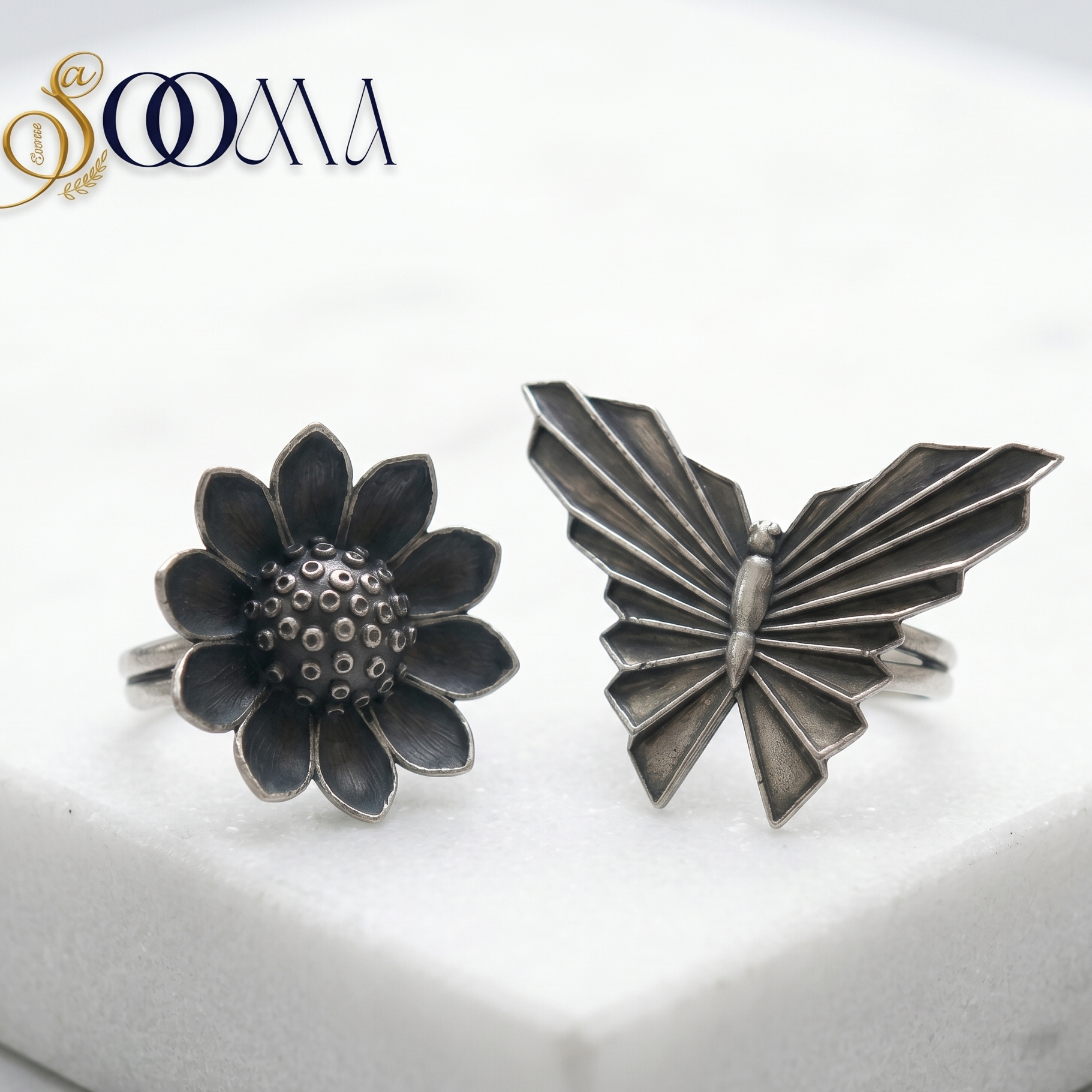 Silver butterfly and flower-shaped cufflinks on a white background with 'Sooma' branding.