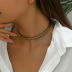 Close up of a  woman in white shirt wearing rust gold traditional hasli necklace.