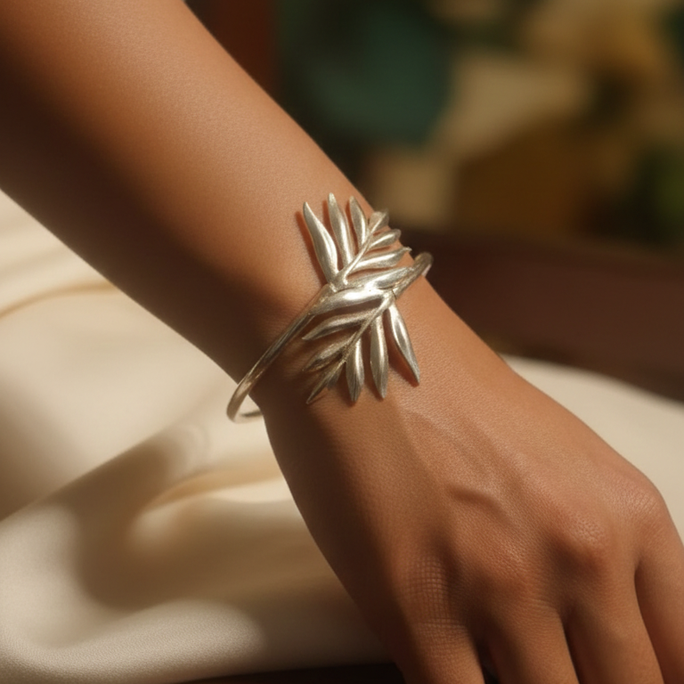 Elegant silver look alike leaf bracelet  on a wrist with a blurred background