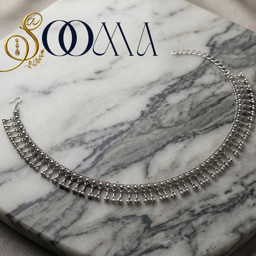 Silver waistbelt on a marble surface with 'Sooma' branding.