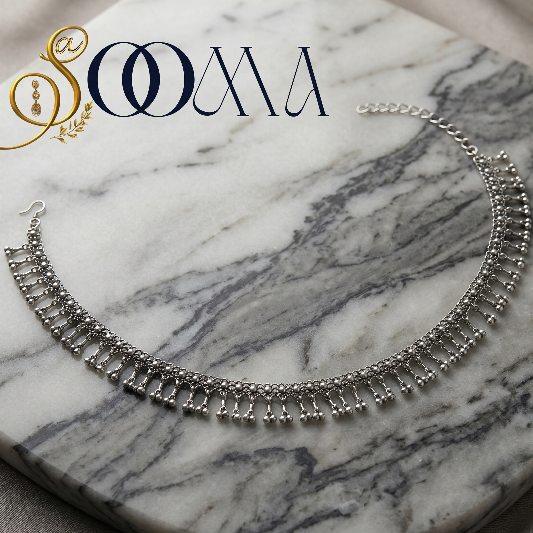 Silver waistbelt on a marble surface with 'Sooma' branding.