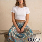 Person wearing sitting on a wooden bench & wearing waist chain adding a touch of glamour to professional attire