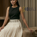 Woman sitting on a couch wearing a Indo-Western waist belt on a woman's waist, highlighting the intricate design and elegant look.