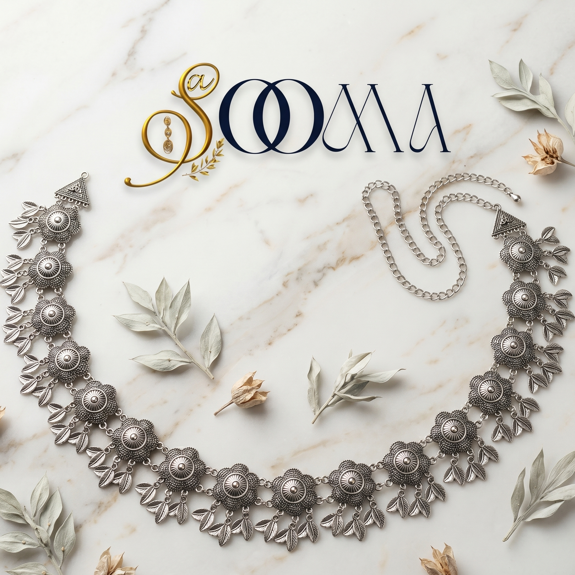 Decorative silver waist belt on a marble surface with 'SOOMA' branding.