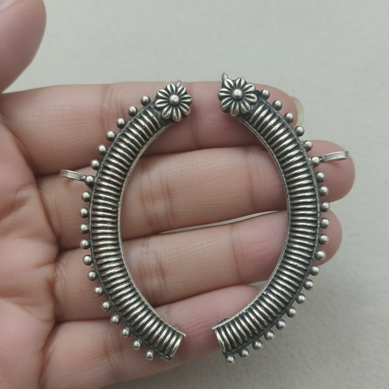 Close-up of oxidised stud earcuffs showing detailed texture and stud setting.