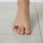 Close-up of elegant silver toe rings on a woman's foot