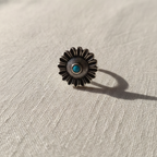 Close-up of a silver floral toe ring on a woman's foot.