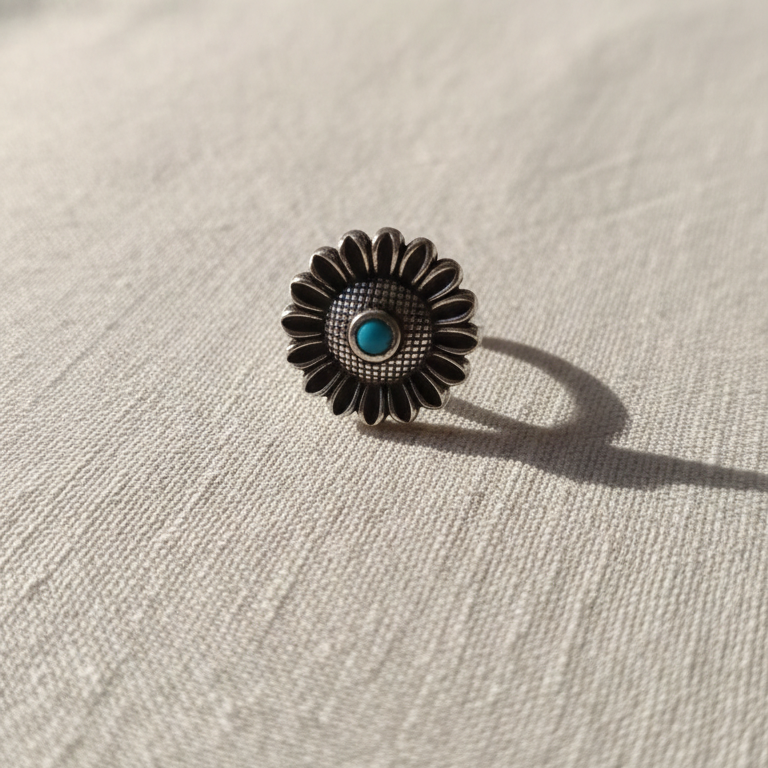 Close-up of a silver floral toe ring on a woman's foot.
