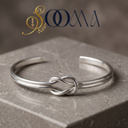 Sooma brand flat lay view of handcrafted silver infinity knot dual-band open ankle cuff displayed on grey stone block