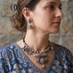 Model in blue block-printed kurti wearing handcrafted oxidized silver tribal statement necklace set with jhumkas